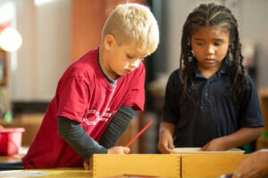 Creative Montessori Academy students work on a project together in the classroom with one another.