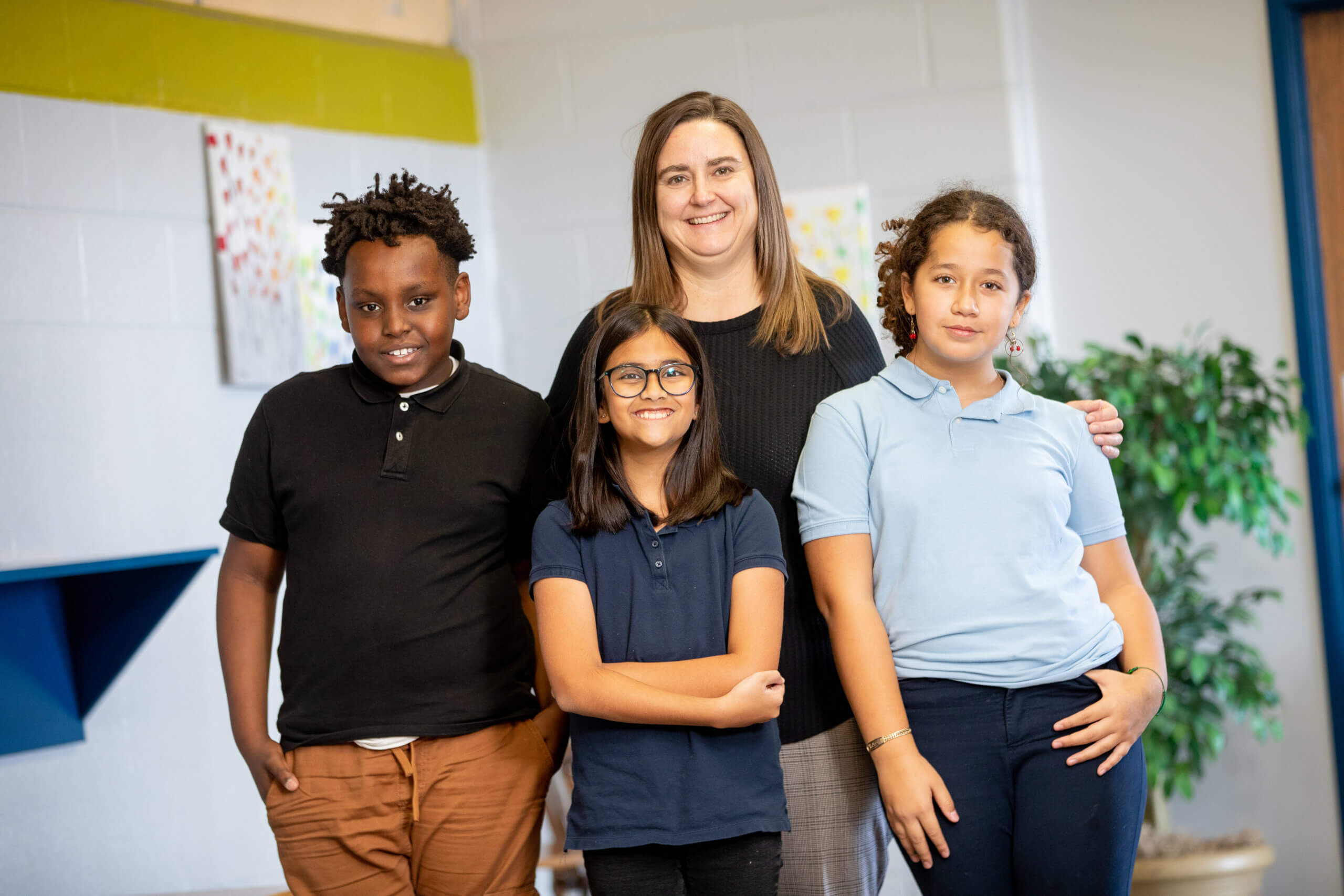 principal, lisa loger standing in hallway with students